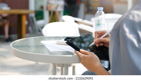 Young Asian Woman Using Personal Tablet For Freelance Job And Working Part Time, Online Education, Training, Blogging Or Online Shopping, Person Working With Online Technology In Modern World Concept.