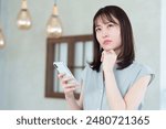 young asian woman using smartphone in trouble