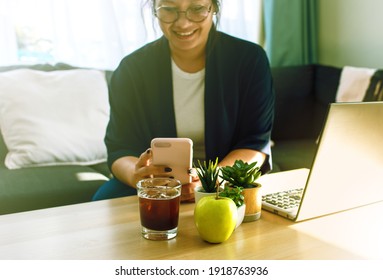 A Young Asian Woman Using Smartphone Taking Picture Via Picture Application Of Her Iced Tea And Green Apple Before Eat To Use For Calorie Counting App And Social Media Post.	