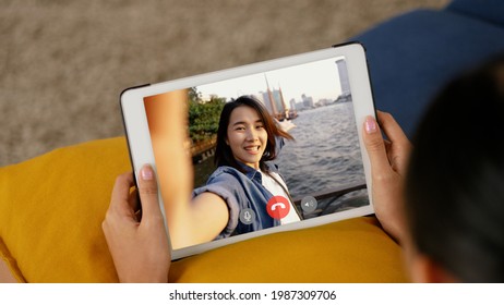 Young Asian woman using tablet video call talking with friends while living at home. Self-isolation, social distancing, quarantine at home. - Shutterstock ID 1987309706