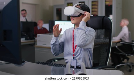 Young Asian Woman In Vr Headset Working At Desk On Computer In Modern Office. Female Scientist Or Engineer Work In Virtual Reality Goggles