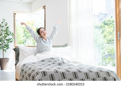 Young Asian Woman Waking Up