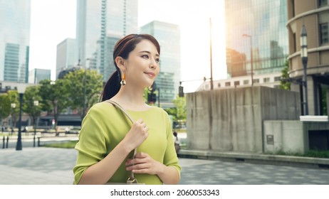 Young Asian Woman Walking In The City.