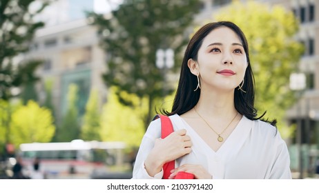 Young Asian Woman Walking In The City.