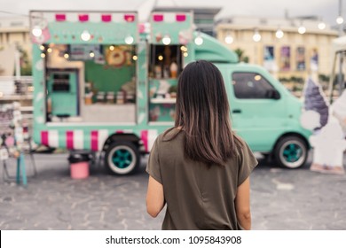 Young Asian Woman Walking In The Food Truck Market