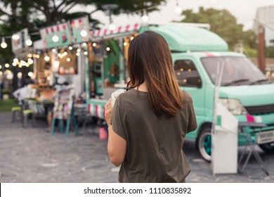 Young Asian Woman Walking In The Food Truck Market