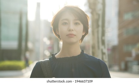 Young asian woman walking on the street.
