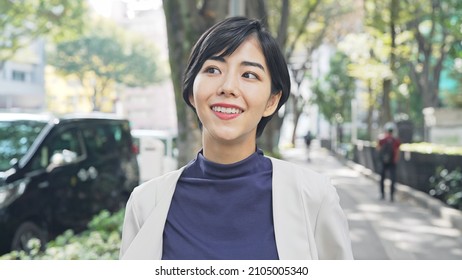 Young Asian Woman Walking On The Street.