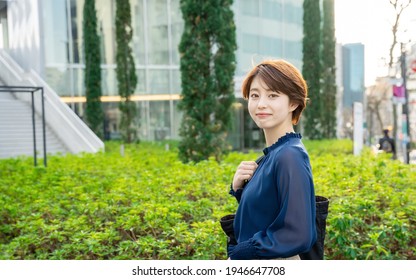 Young asian woman walking in the town.