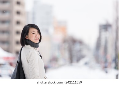 Young Asian Woman Walking In A Winter City.