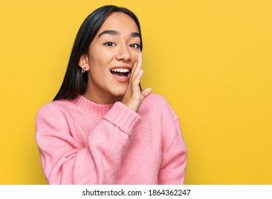 Young Asian Woman Wearing Casual Winter Sweater Hand On Mouth Telling Secret Rumor, Whispering Malicious Talk Conversation 