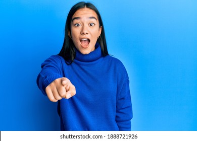 Young Asian Woman Wearing Casual Winter Sweater Pointing Displeased And Frustrated To The Camera, Angry And Furious With You 
