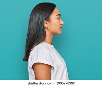 Young Asian Woman Wearing Casual White T Shirt Looking To Side, Relax Profile Pose With Natural Face With Confident Smile. 