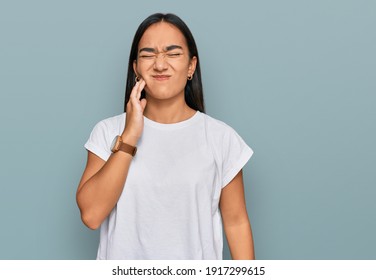 Young Asian Woman Wearing Casual White T Shirt Touching Mouth With Hand With Painful Expression Because Of Toothache Or Dental Illness On Teeth. Dentist 