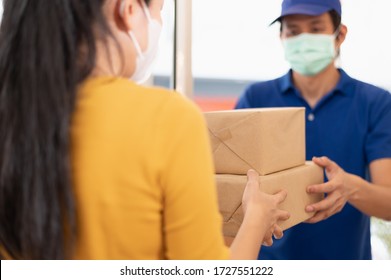 Young Asian Woman Wearing Face Mask Or Surgical Mask Signing On Digital Tablet For Receiving Package From Delivery Service Company Staff For Prevent Coronavirus Infection During Covid-19 Outbreak.