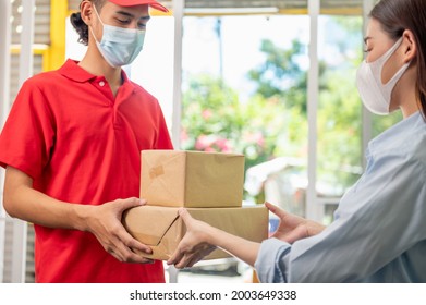 Young Asian Woman Wearing Face Mask Receiving Parcel Post Package From Delivery Service Company Staff At Home For Prevent Coronavirus Infection, Food Delivery During Covid-19 Outbreak.