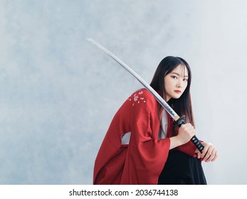 Young asian woman wearing kimono. Japanese girl. Samurai girl.