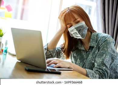 Young asian woman wearing mask protect covid-19 feeling strain fatigue and have a fever during working with laptop in her home. work from home concept