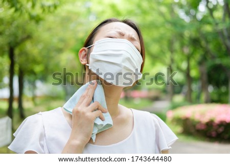 young asian woman wearing mask in summer