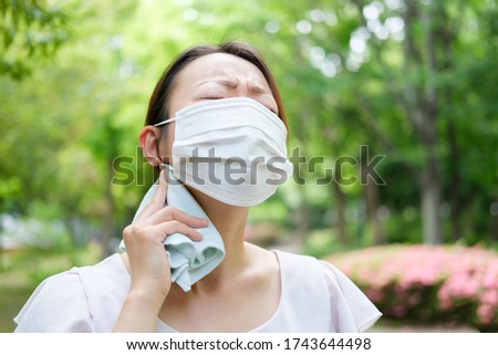 young asian woman wearing mask in summer