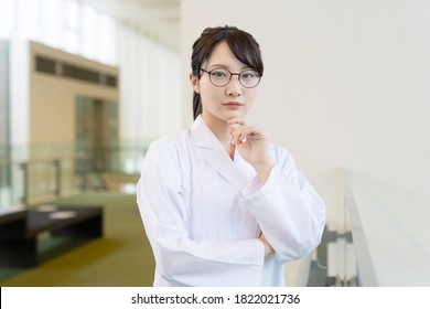 Young Asian Woman Wearing A White Robe. Medical School Student. Science School Student.