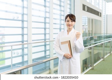 Young Asian Woman Wearing A White Robe. Medical School Student. Science School Student.