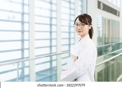 Young Asian Woman Wearing A White Robe. Medical School Student. Science School Student.