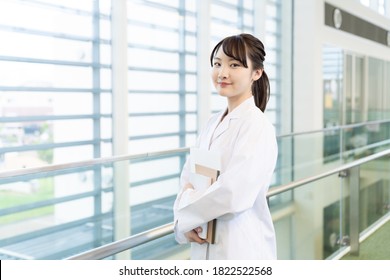 Young Asian Woman Wearing A White Robe. Medical School Student. Science School Student.