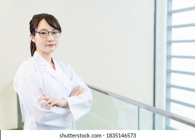 Young Asian Woman Wearing A White Robe. Medical School Student. Science School Student.