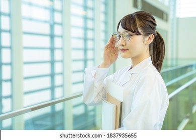 Young Asian Woman Wearing A White Robe. Medical School Student. Science School Student.