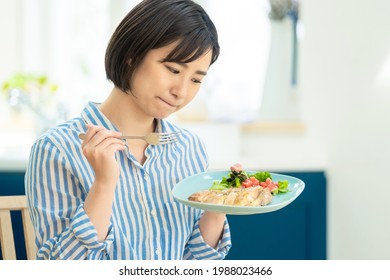 Young asian woman who is in trouble because she cannot eat meat dishes. - Shutterstock ID 1988023466