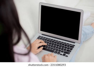 Young asian woman work from home with laptop computer blank screen mockup, freelance is female using notebook with display empty, girl typing keyboard, business and communication concept. - Shutterstock ID 2311080293