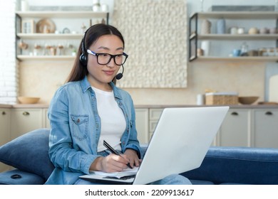 Young Asian Woman Working From Home Remotely Online, Businesswoman Using Headset And Laptop For Video Call, Woman Working In Tech Support And Customer Service