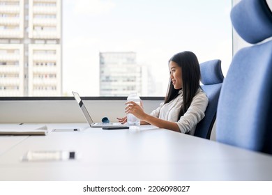 Young Asian Woman Working With Laptop In Office