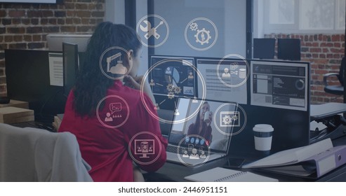 Young Asian woman working with multiple screens, analyzing data. She is in an office setting, engaged in complex tasks with futuristic interface graphics. - Powered by Shutterstock