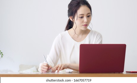 Young asian woman working in the room. - Shutterstock ID 1667057719