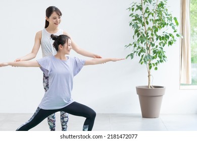 Young Asian Women Doing Yoga Indoors