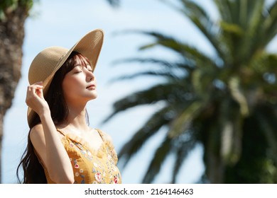 Young Asian women enjoying the resort - Powered by Shutterstock