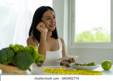 Young Asian women are losing weight, choosing to eat fruits and vegetables for good health. Women are planning a healthy diet to eat at each meal. Diet concept - Shutterstock ID 1843402774