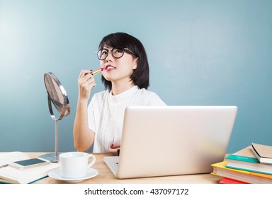 Young Asian Women Make Up With Workspace Table