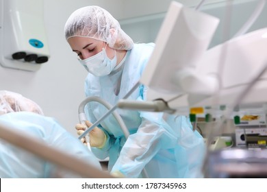 A Young Assistant At A Dental Operation Under General Anesthesia. Pediatric Dentistry. Copy Space. The Concept Of Health.