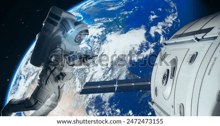 Young Astronaut Floating in Space in Zero Gravity. Spaceman Using Laptop Computer in Open Space Outside an Orbiting Spacecraft, Browsing Instruction Manuals for Maintenance Work on a Satellite