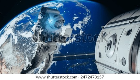 Young Astronaut Floating in Space in Zero Gravity. Spaceman Using a Laptop Computer in Open Space Outside an Orbiting Spacecraft, Browsing Instruction Manuals for Maintenance Work on a Satellite