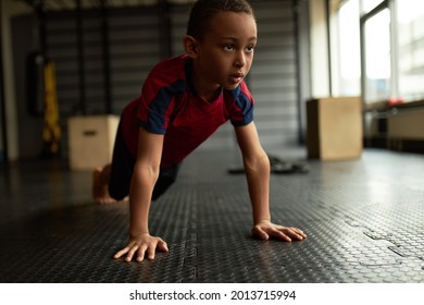 Young athlete boy doing push ups in sports schools for children. Physical exercise to waste kids extra energy with good for health. Sportsman, sport, hobby, healthy lifestyle concept