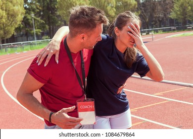 Young Athlete Injured To Knee On The Track While Being Helped By His Coach And His Teammates