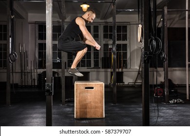 Young Athlete Man Doing A Box Jump Exercise In The Gym