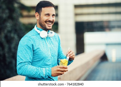 Young Athlete Man Eating Fruit After Exercising. 