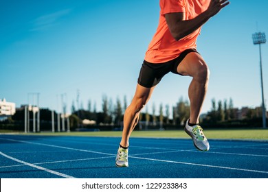 Young athlete man starting to run in a start position in a race. Start stride  - Shutterstock ID 1229233843