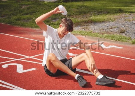 Similar – Image, Stock Photo Young athlete refreshes himself with water after a hard workout on the athletic oval in the intense heat. Endurance training. Brown-haired adolescent
