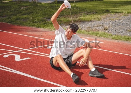Similar – Image, Stock Photo Young athlete refreshes himself with water after a hard workout on the athletic oval in the intense heat. Endurance training. Brown-haired adolescent